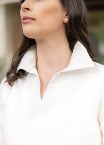 Close up of a collar on a cream women's dress