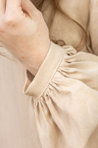 Close-up of beige fabric with a focus on texture and color.